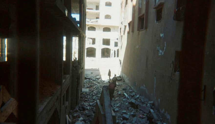 This photo provided by Breaking the Silence, a whistleblower group of former Israeli soldiers, shows two soldiers behind Palestinian detainees being sent into a Gaza City-area house to clear it in 2024.