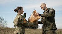 Polish and Romanian NATO soldiers swap rations