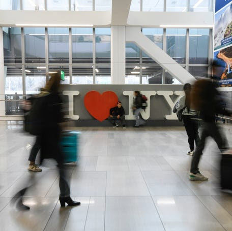 Passengers with their bags at LaGuardia Airport terminal B.