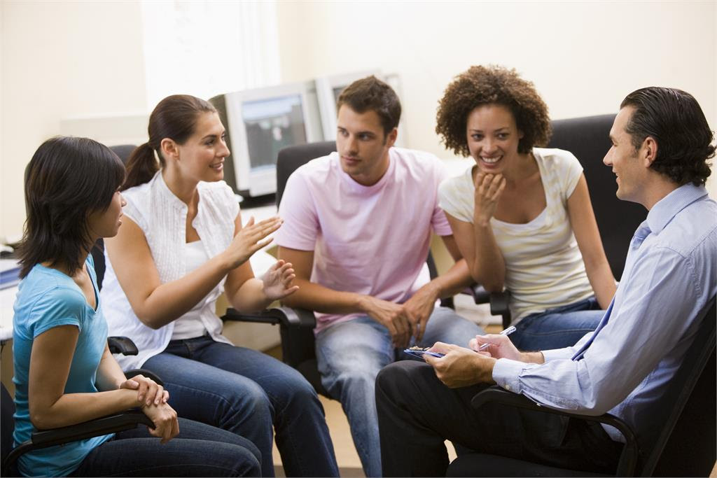 man-giving-lecture-to-four-people-in-computer-.jpg