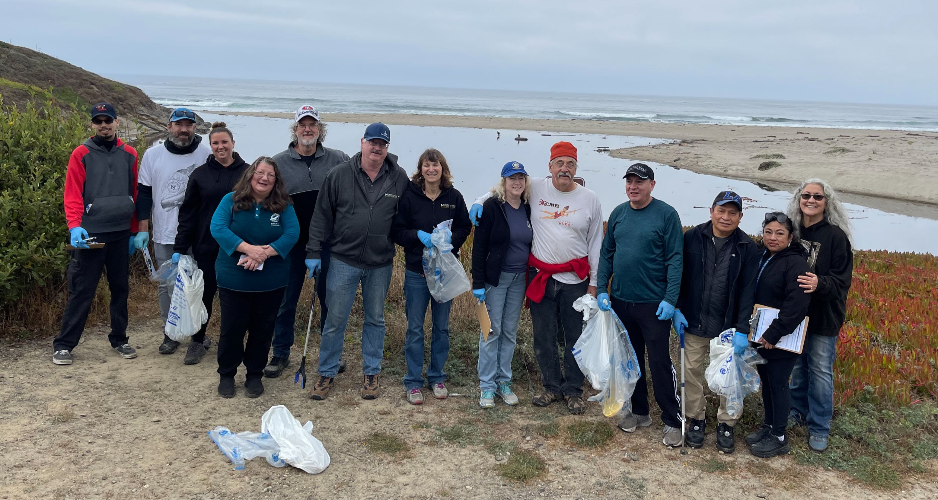 Group photo of North Coast Brewing employees on a beach cleanup day.
