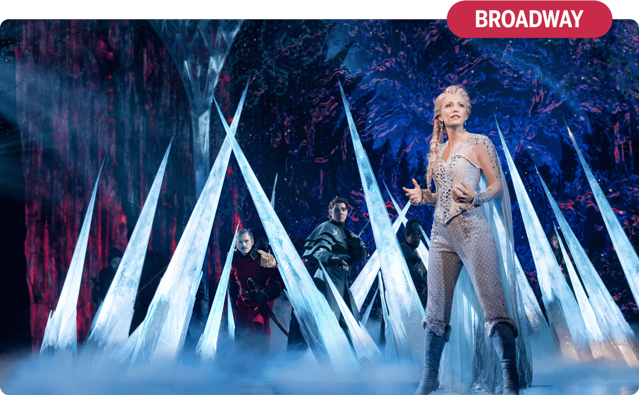 Broadway performer Caroline Bowman appears on stage as Elsa in the musical FROZEN, surrounded by icicles. 