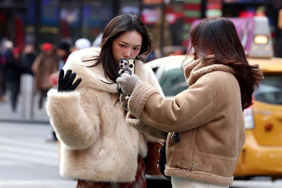 A social media influencer films a video in Times Square in New York City