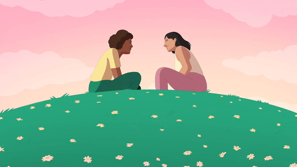 An illustration of two people sitting and facing one another on a grassy field. They are engaged in a conversation. The sky is pink and orange. 