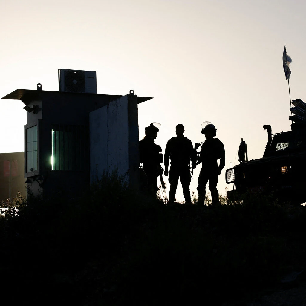 The shadows of soldiers, carrying guns. 