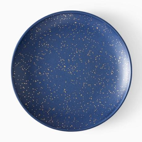 A blue plate with gold speckled specksDescription automatically generated