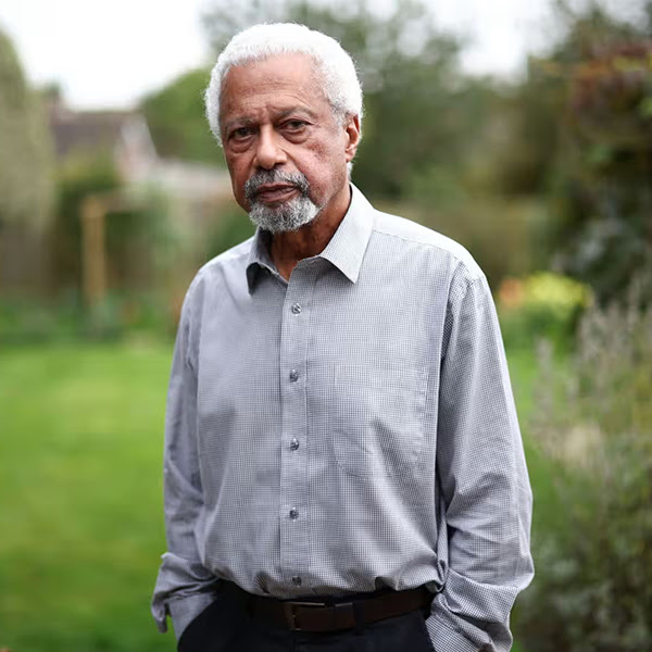 A man standing in a garden and looking at the camera