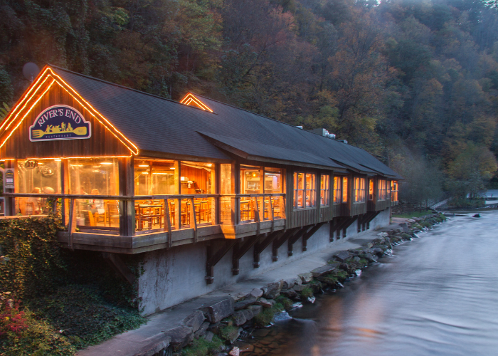 a Restaurant on the river with twinkling lights