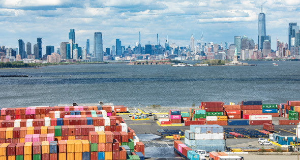 aerial view of colorful shipping containers at the port of new york and new jersey with the new york city skyline in the background 