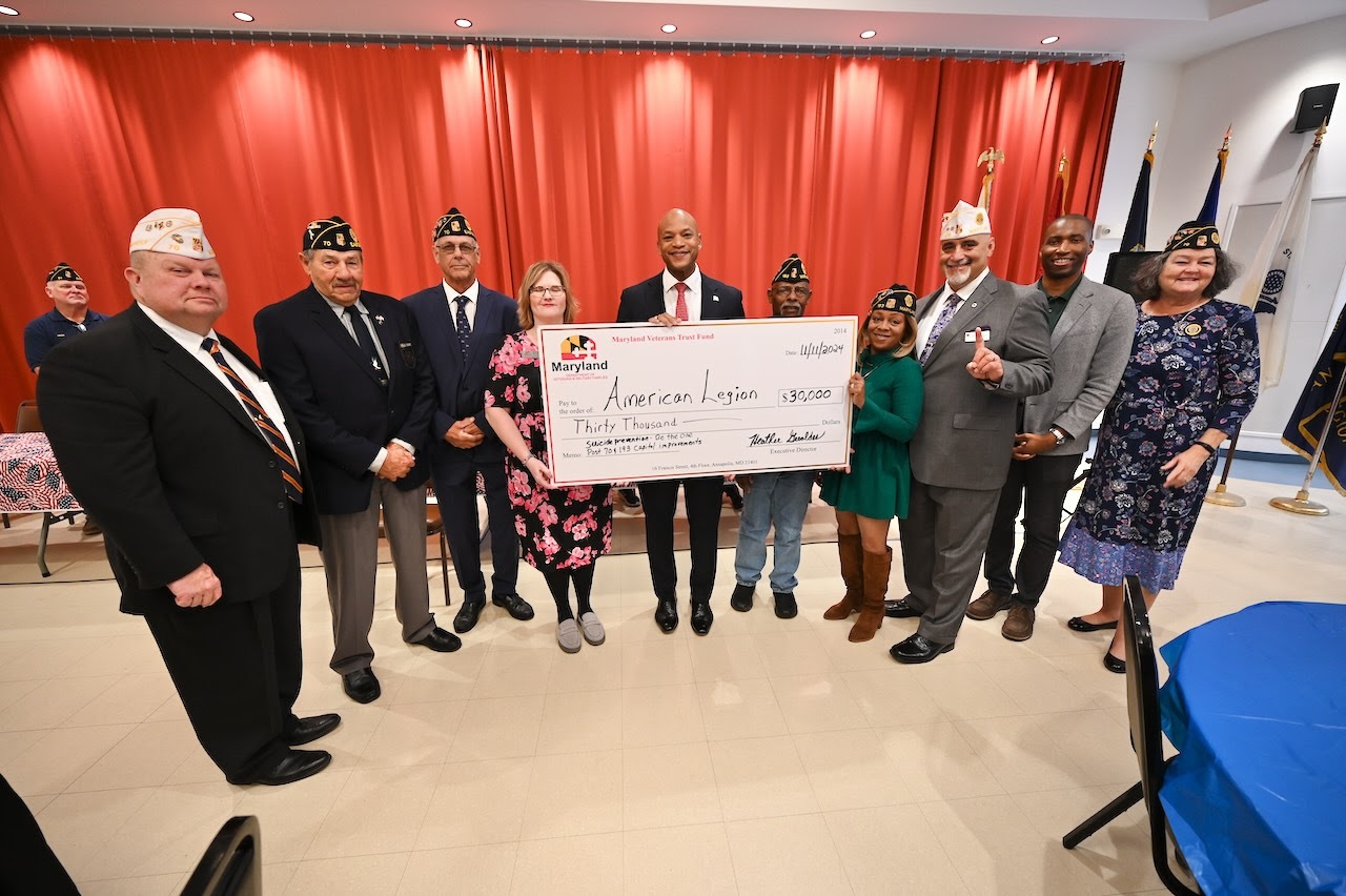 Governor Moore holding cheque with others