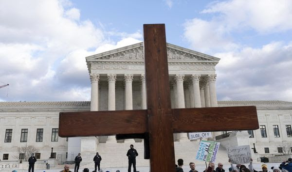 Anti-abortion activists hold a cross as they rally outside of the U.S. Supreme Court during the March for Life in Washington, Friday, Jan. 20, 2023. (AP Photo/Jose Luis Magana, File)