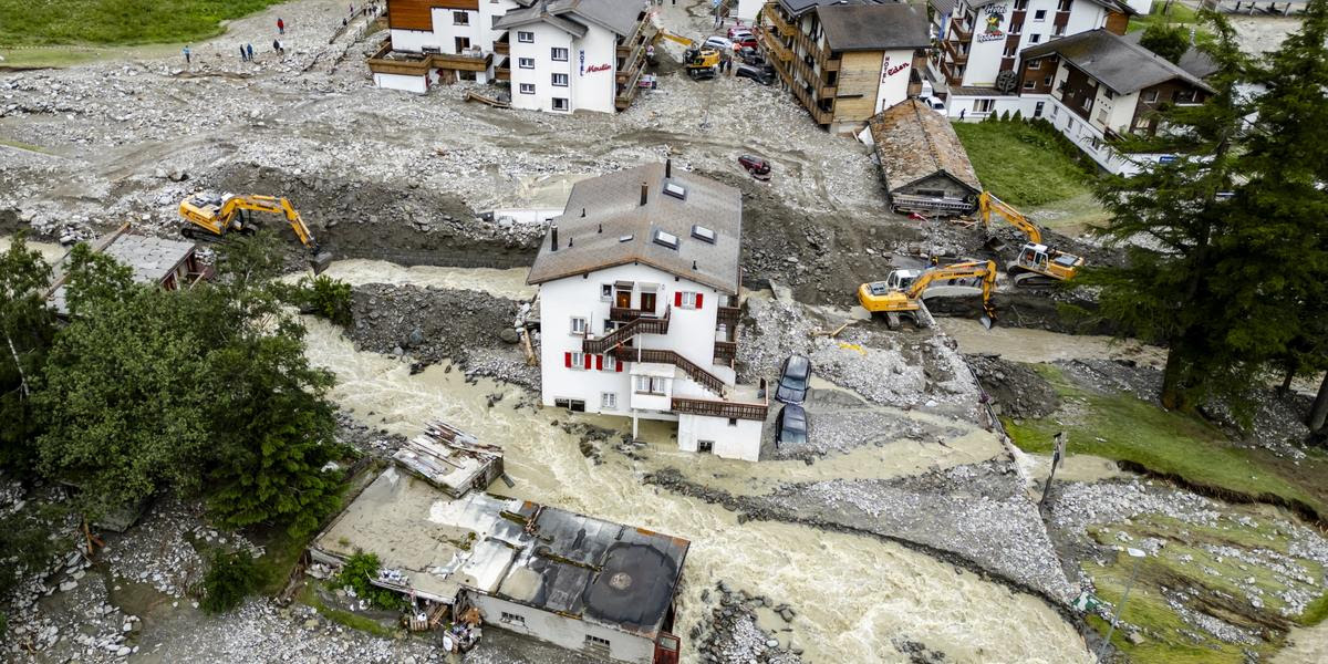 epa11447401 Buildings stand amid the rubble from a landslide following storms that caused major flooding in Saas-Grund, in the canton of Valais, Switzerland, 30 June 2024. Massive thunderstorms and rainfall led to a flooding situation with large-scale landslides. One person was found dead in a hotel in Saas-Grund. EPA/JEAN-CHRISTOPHE BOTT