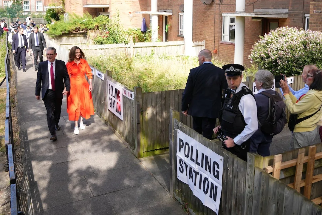 Keir Starmer and his wife Victoria Starmer walk outside a polling station