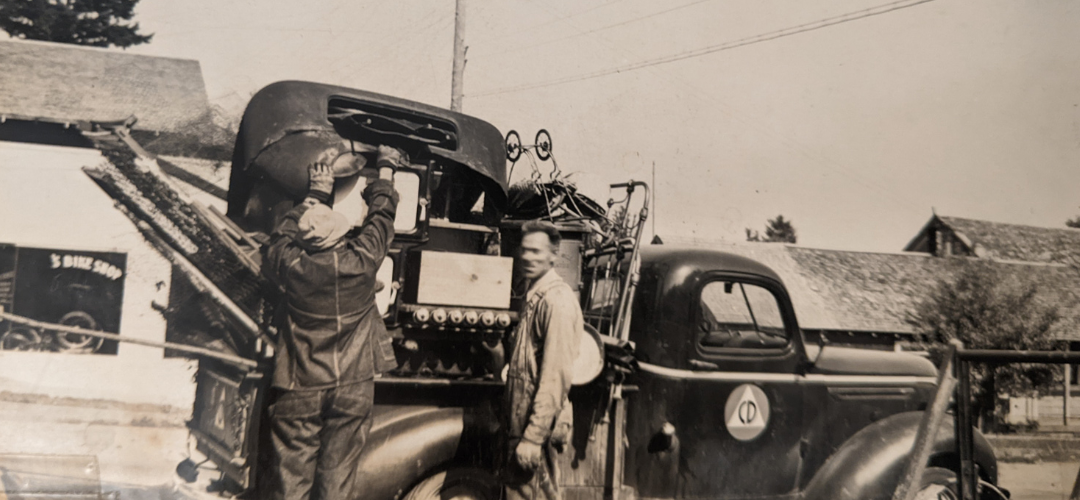 Image of two men with a truck full of scrap metal