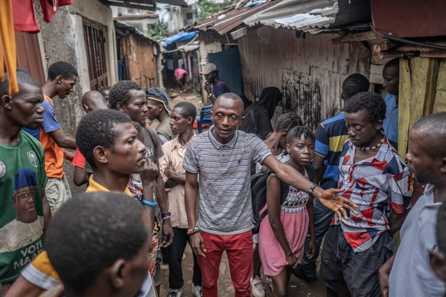 Ibrahim Koroma of the Mental Watch Advocacy Network, a local civil society organization, warns of the dangers of kush in a poor neighborhood in Western Freetown, Sierra Leone. "Young people are losing their lives," says Koroma, "especially in these poor communities."