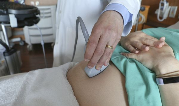 In this Aug. 7, 2018 photo, a doctor performs an ultrasound scan on a pregnant woman at a hospital in Chicago. (AP Photo/Teresa Crawford, File)