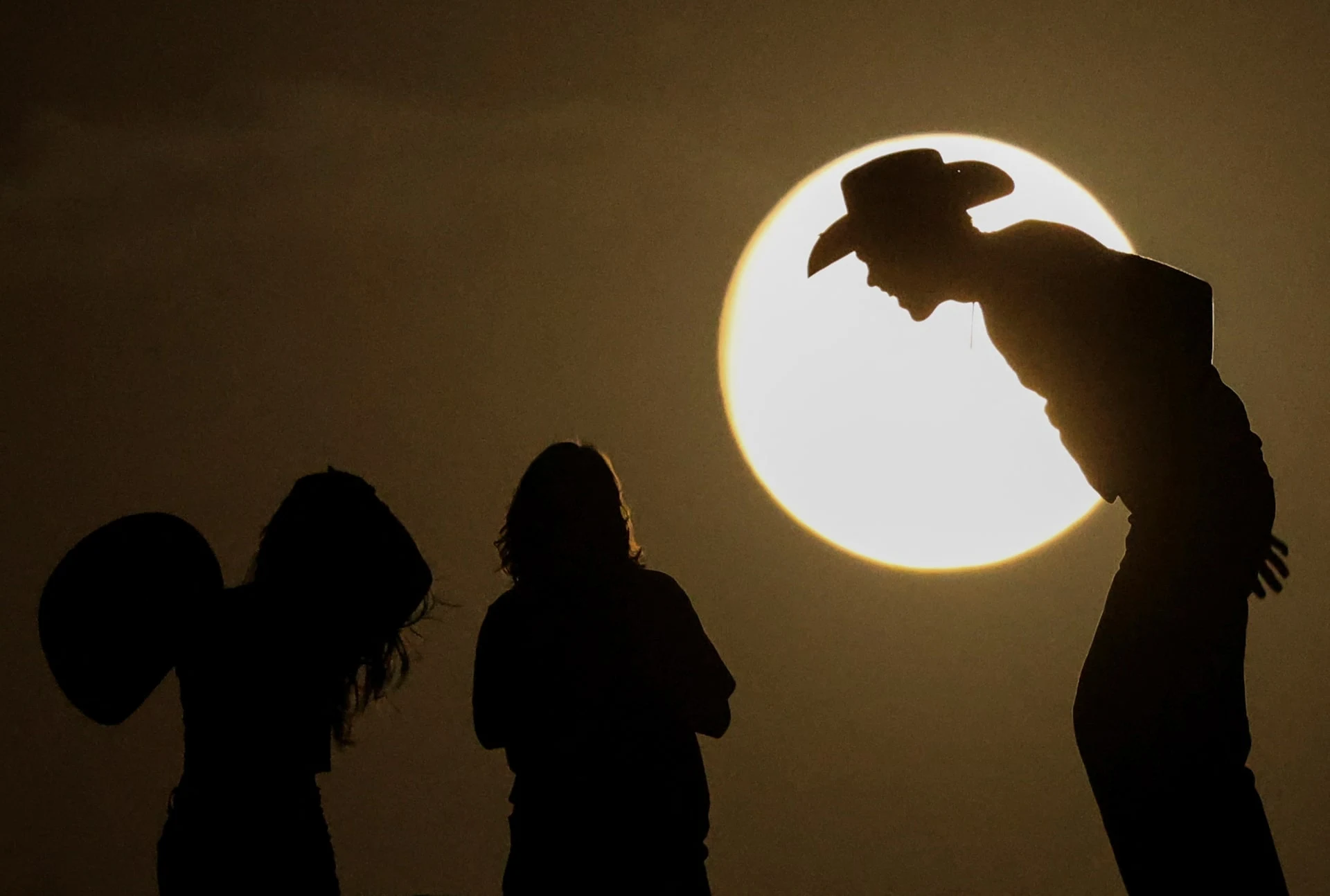 People watch the full moon on the day of the lunar eclipse at the Samalayuca Dunes on the outskirts of Ciudad Juarez, Mexico, September 17. 