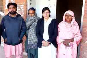 Sufyan Masih is on the left. he is standing with three other people.