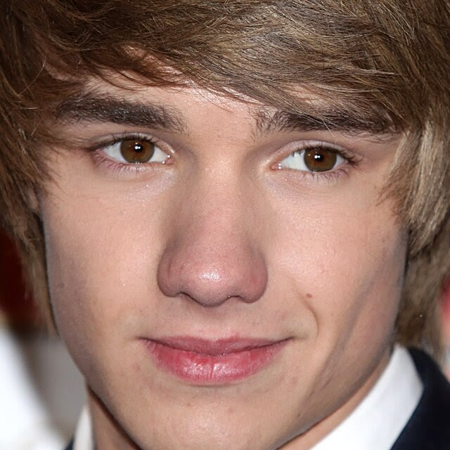 A close-up photo of a wistful-looking young man.