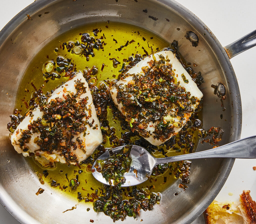 Two fish filets smothered in scallion oil.