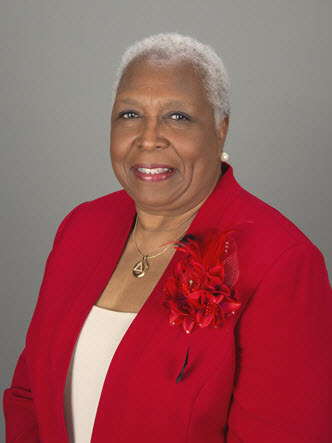 Headshot of Dr. Olivia G. White in a red blazer smiling at camera.