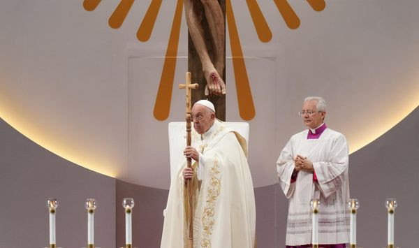 Pope Francis, left, leads a holy mass at the SportsHub National Stadium in Singapore, Thursday, Sept. 12, 2024. (AP Photo/Vincent Thian)