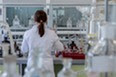 A person working in a science lab, surrounded by scientific equipment.