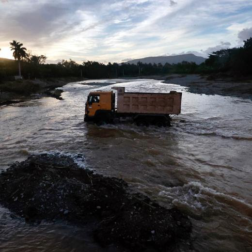 A truck crosses an flooded river near the town of Imias in Guantanamo Province, Cuba, on October 30, 2024, more than a week after the passage of Hurricane Oscar. Hurricane Oscar struck Cuba on October 20 as a Category 1 storm. (Photo by Ernesto Mastrascusa / POOL / AFP)