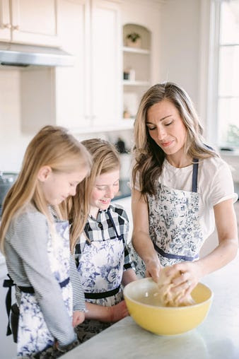 mom baking with two daughters