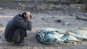 a person reacts next to a body in the aftermath of an israeli strike on a house amid the israel hamas conflict in deir al balah in the central gaza strip december 22 2024 reuters jpg