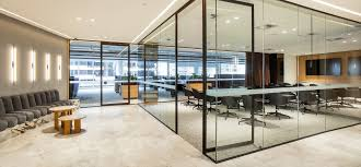 luxurious office interior with a spacious layout, featuring glass partitions, modern furniture, and a well-lit meeting area that reflects a sophisticated corporate environment.