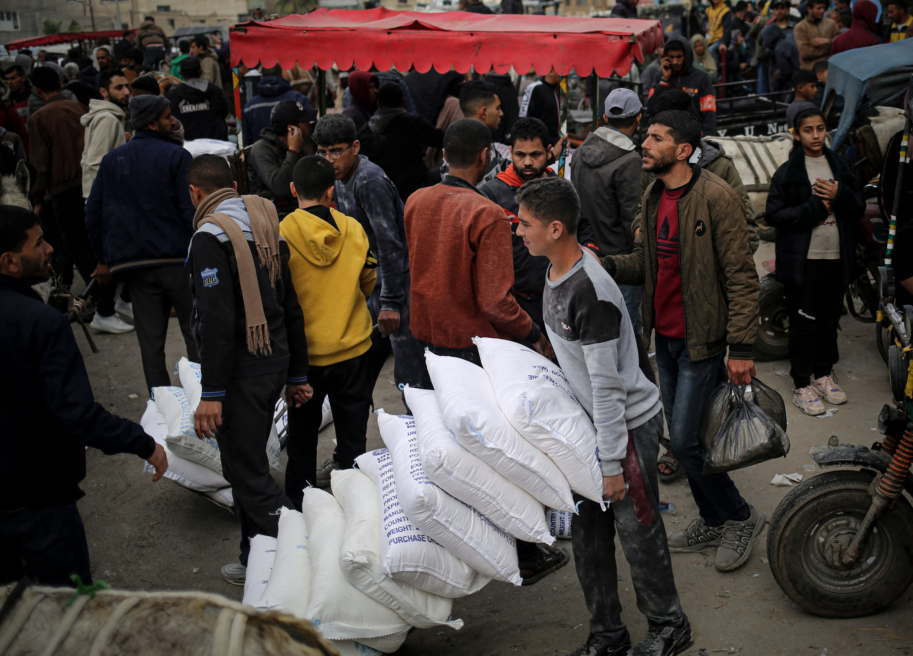 A man transports aid in the southern Gaza Strip on March 3, 2024. (Photo by AFP via Getty Images.)