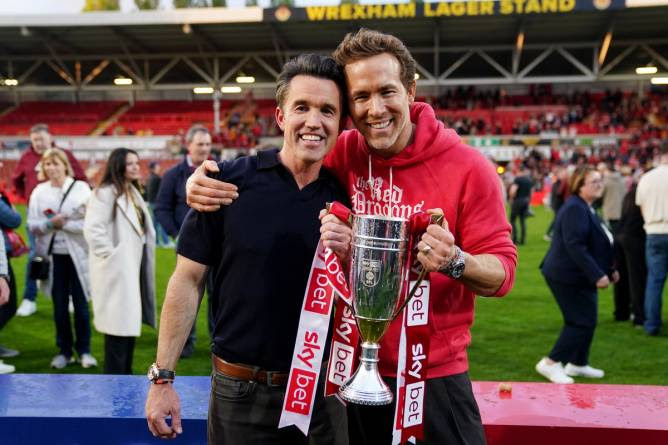 Wrexham co-owners Ryan Reynolds (right) and Rob McElhenney celebrate with the trophy 