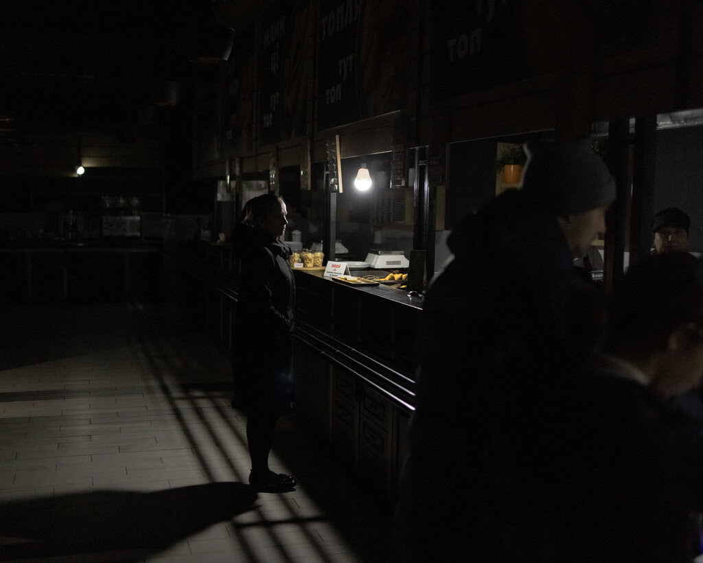 A woman standing in a dimly lit restaurant. 