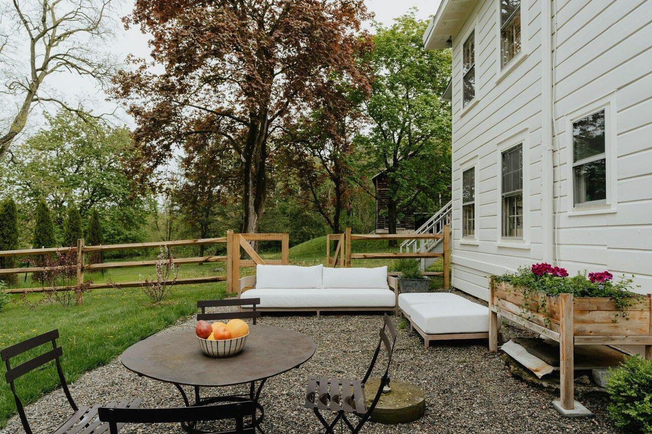 An outdoor space at a home with a table and sofas.