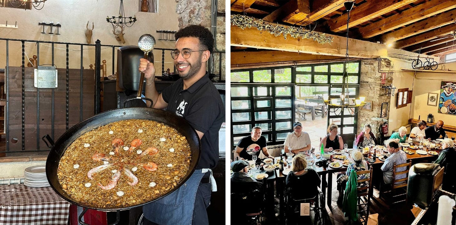 Large paella served to group in historic restaurant.