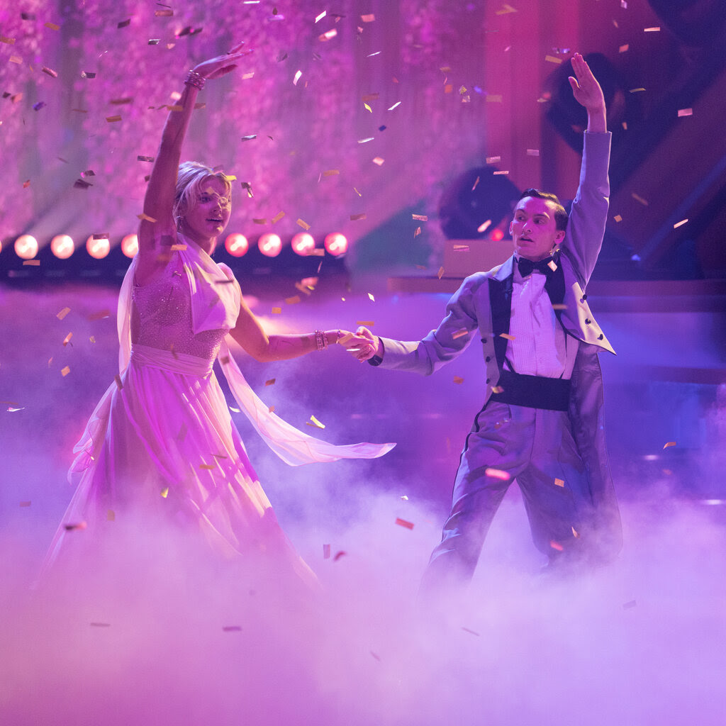 Rylee Arnold, left, and Stephen Nedoroscik hold a dance pose while in a cloud of colored smoke.