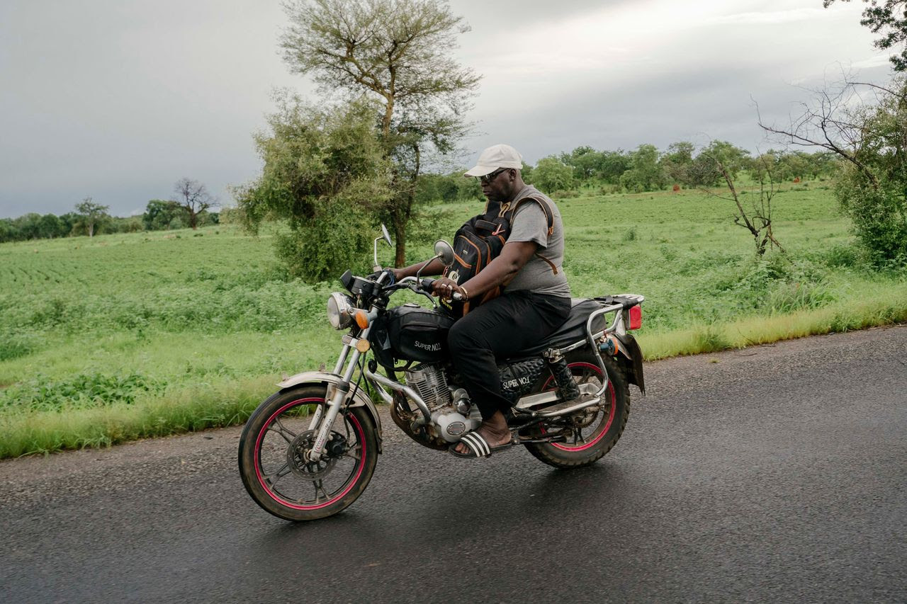 Momodou Keita, a 51-year-old father of five, patrols on his motorbike named “Super Star.” (Carmen Yasmine Abd Ali for The Washington Post)