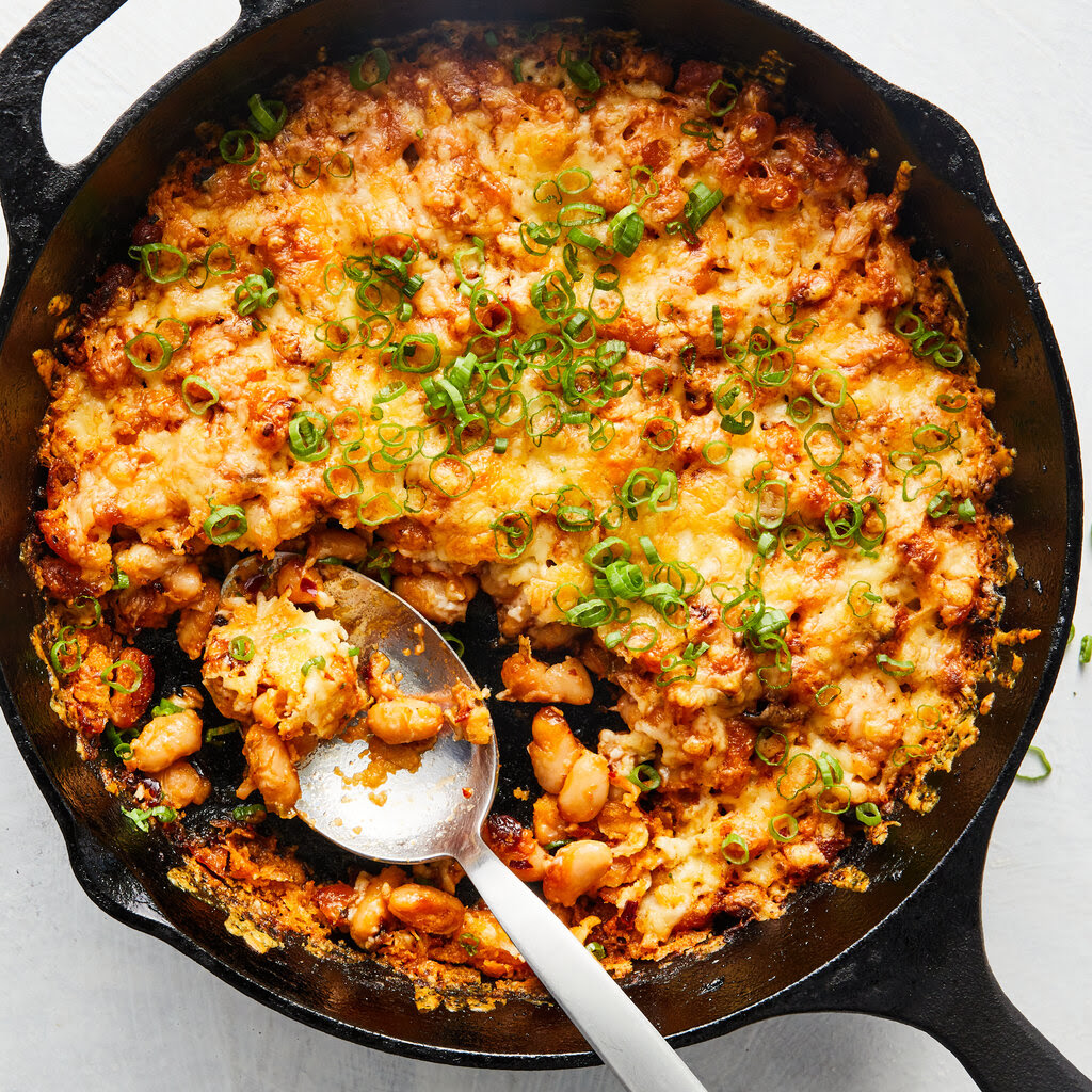 A top-down view of cheesy chili crisp baked white beans.