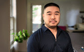 Man in his home looking directly into camera.