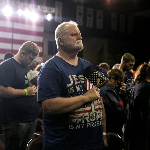 People praying at a Trump rally in July in Erie, Pa.