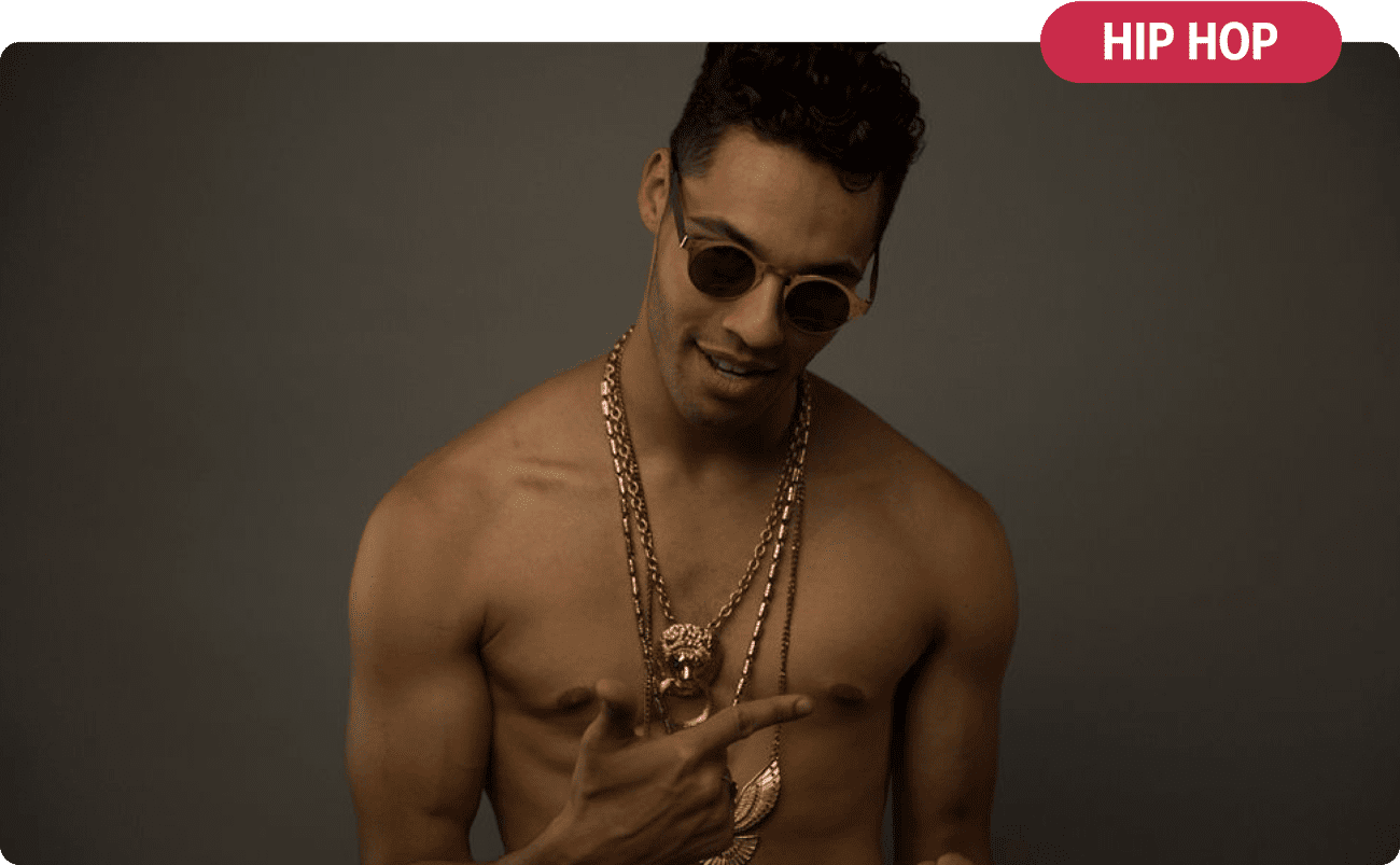 Hip Hop and theatre artist Sébastien Heins wears sunglasses and chunky gold necklaces. 