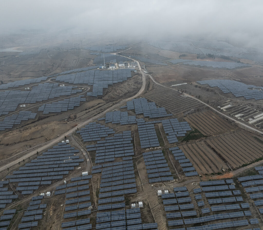 Aerial view of fields of solar panels stretching to the horizon.