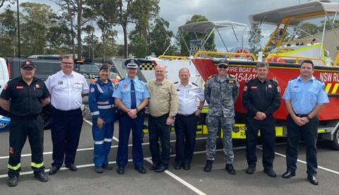 Emergency services personnel stand in a line
