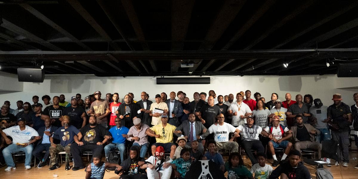 Attendees pose for photos after a Black Man Lab meeting to discuss the candidacy of Vice President Kamala Harris, Monday, July 22, 2024, in Atlanta. (AP Photo/Stephanie Scarbrough)