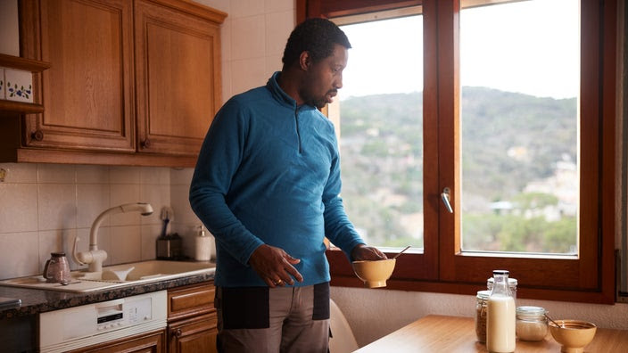 Man finishing breakfast in the kitchen