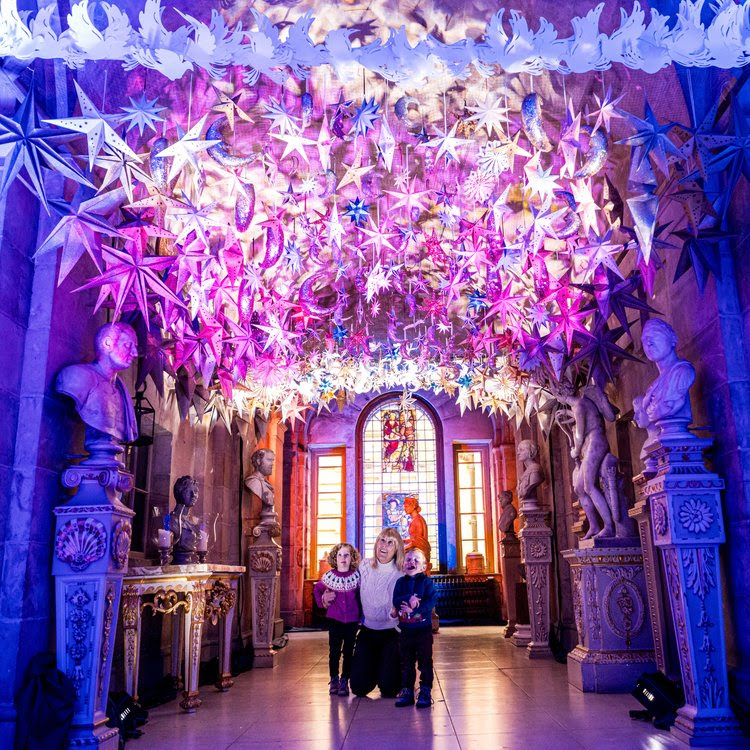 Visitors look up in amazement at the Christmas light installation at Castle Howard.