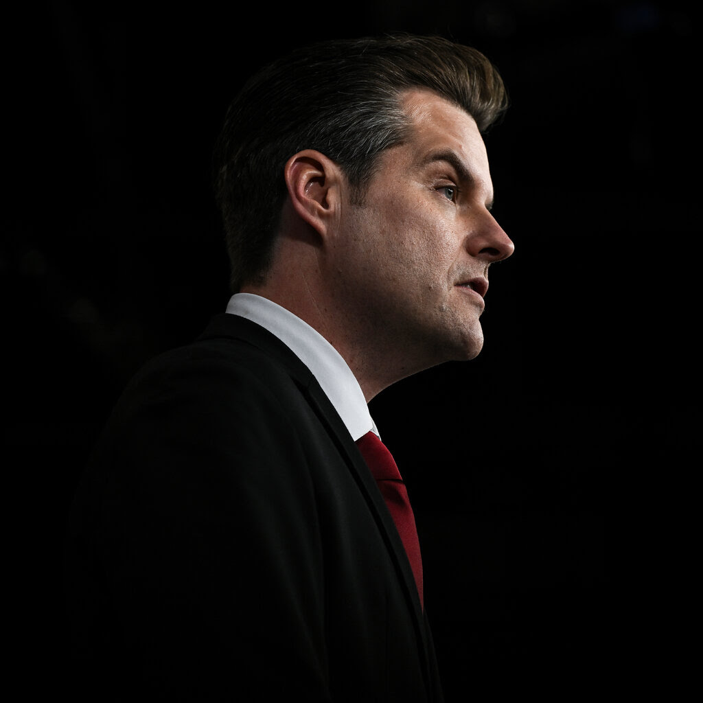 Matt Gaetz seen in profile against a dark background.