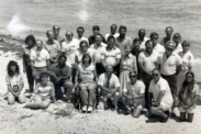 Black and white image of Southeast Fisheries Science Center staff posing together on a beach in Miami, Florida