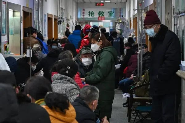 People wearing masks wait for medical attention at Wuhan Red Cross Hospital in Wuhan, China, on Jan. 25, 2020. (Hector Retamal/AFP via Getty Images)